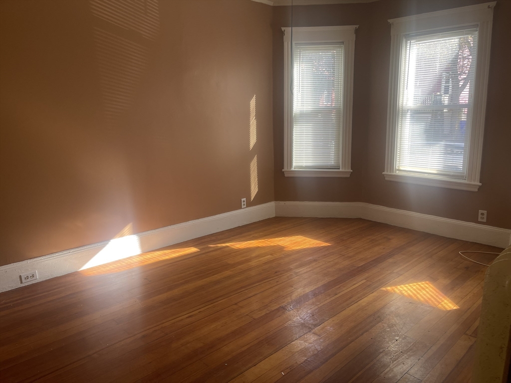 6 Bailey Street, Unit 1 Boston, MA 02124 - Photo 5 of 12 a view of empty room with wooden floor and fan