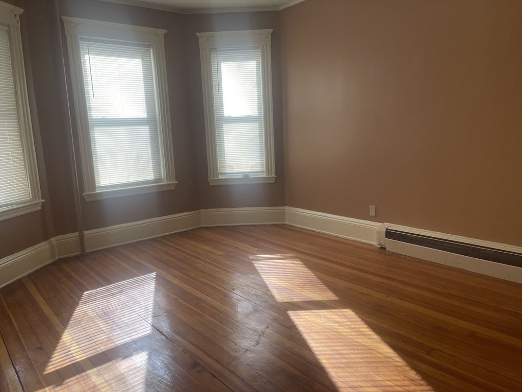 6 Bailey Street, Unit 1 Boston, MA 02124 - Photo 6 of 12 a view of a room with wooden floor and window
