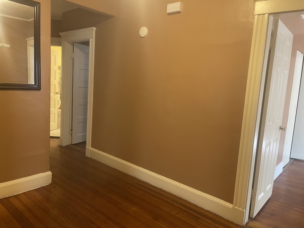 6 Bailey Street, Unit 1 Boston, MA 02124 - Photo 8 of 12 an empty room with wooden floor and entrance