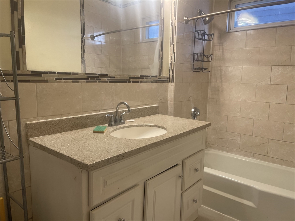 6 Bailey Street, Unit 1 Boston, MA 02124 - Photo 10 of 12 a bathroom with a sink and a mirror