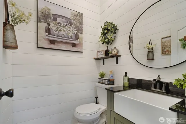 a bathroom with a toilet a sink and a mirror