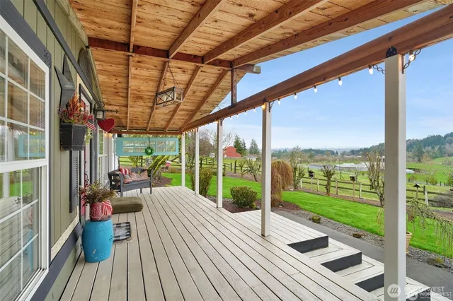 a view of a living room and floor to ceiling windows
