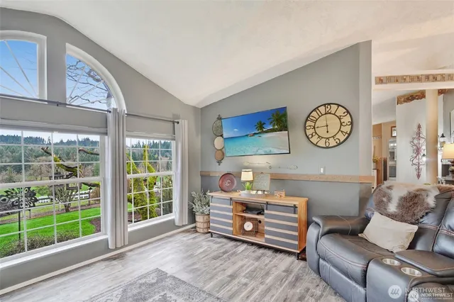 a room with furniture a large window and a clock