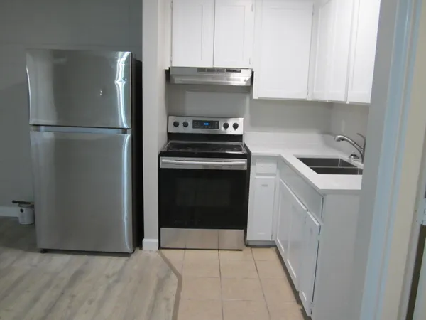 a kitchen with a stove and a refrigerator