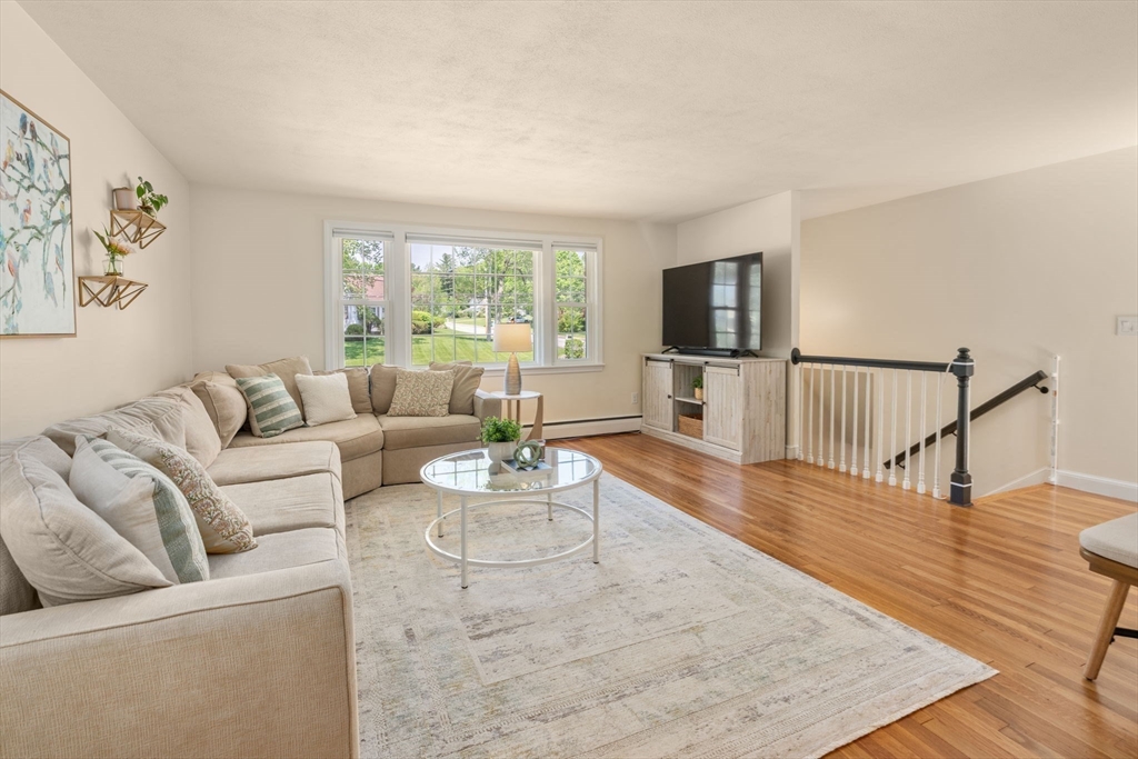 11 Longmeadow Road Medfield, MA 02052 - Photo 3 of 39 a living room with furniture wooden floor and a flat screen tv