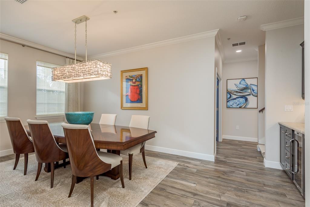 600 Reserve Court, Unit 600 Dunedin, FL 34698 - Photo 18 of 81 a view of a dining room with furniture a chandelier and wooden floor