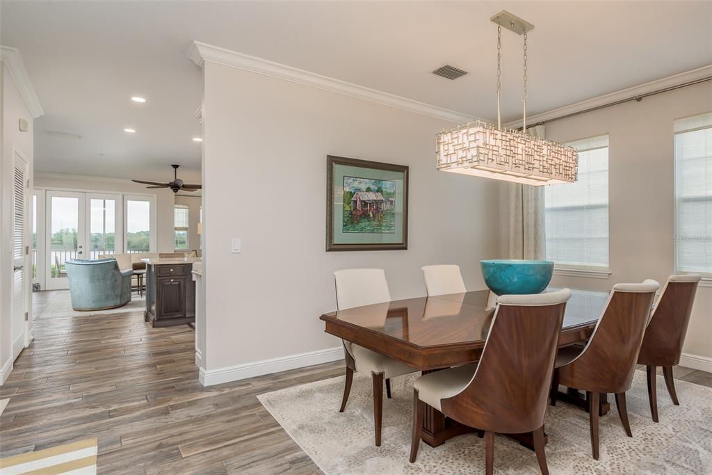 600 Reserve Court, Unit 600 Dunedin, FL 34698 - Photo 19 of 81 a view of a dining room with furniture wooden floor and chandelier