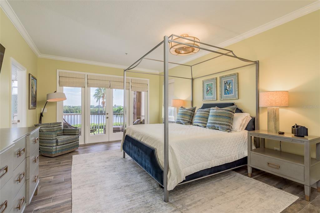 600 Reserve Court, Unit 600 Dunedin, FL 34698 - Photo 32 of 81 a bedroom with a bed and large glass window