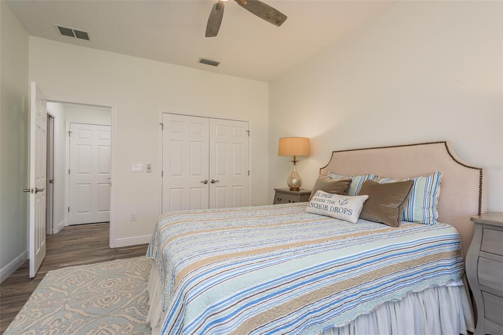 600 Reserve Court, Unit 600 Dunedin, FL 34698 - Photo 38 of 81 a bedroom with a bed and a ceiling fan