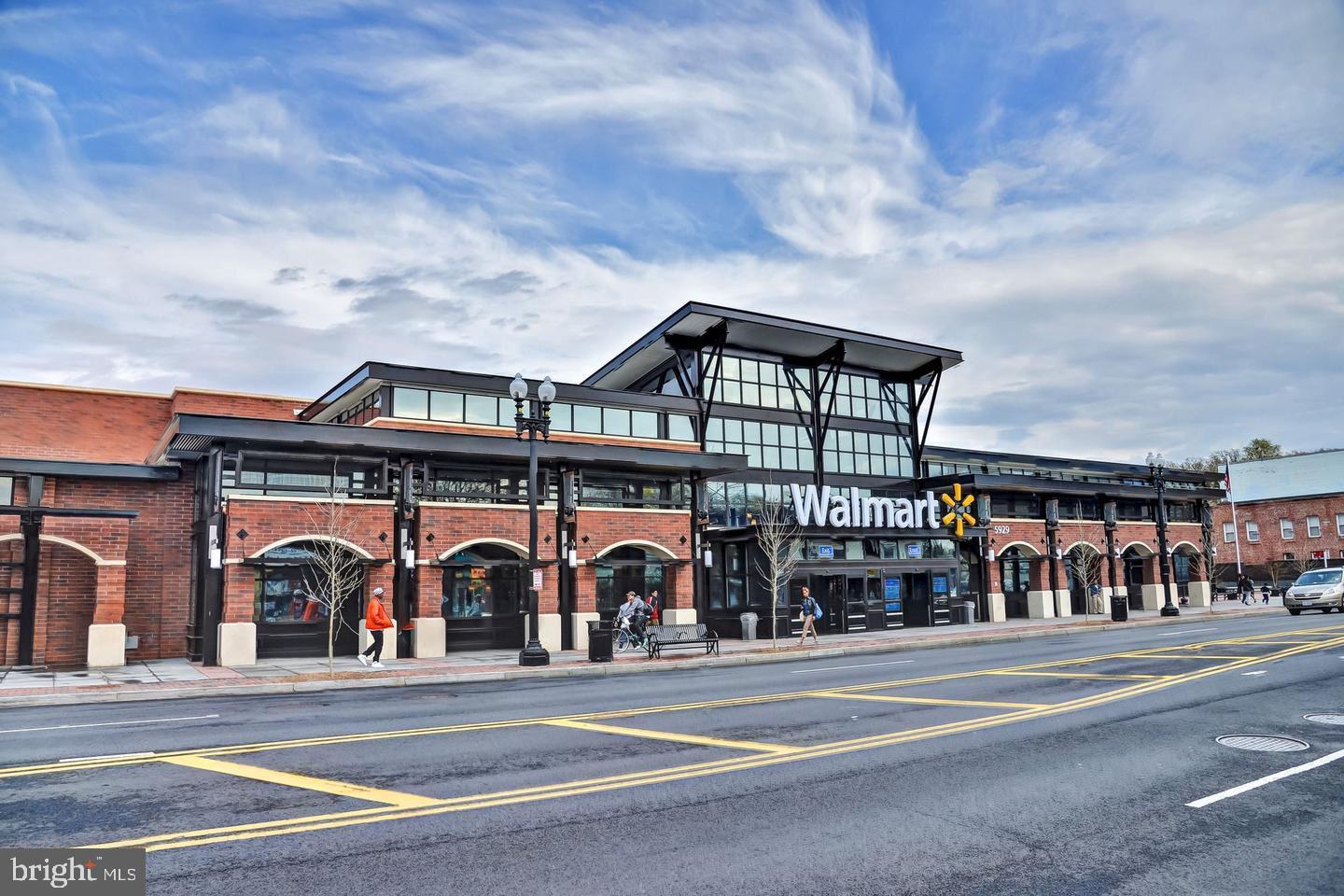 236 Farragut Street Northwest, Unit H203 Washington, DC 20011 - Photo 25 of 30 a man walking down a street next to a building