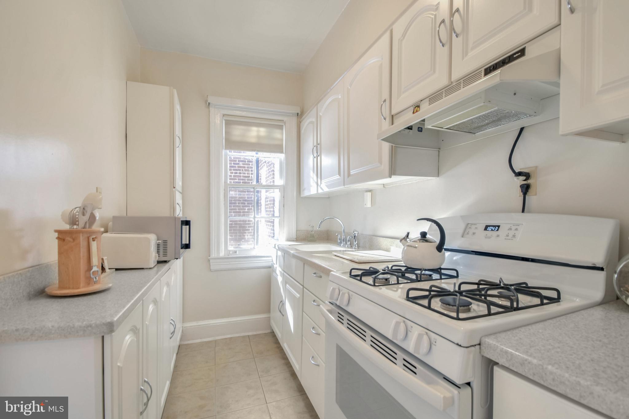 236 Farragut Street Northwest, Unit H203 Washington, DC 20011 - Photo 7 of 30 a white stove top oven sitting inside of a kitchen