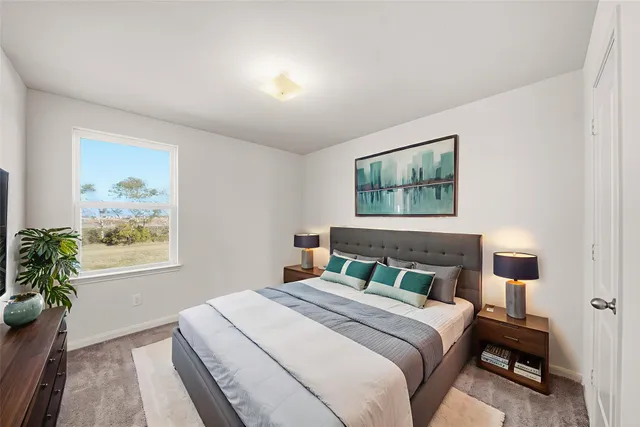 a bedroom with a large bed and a window