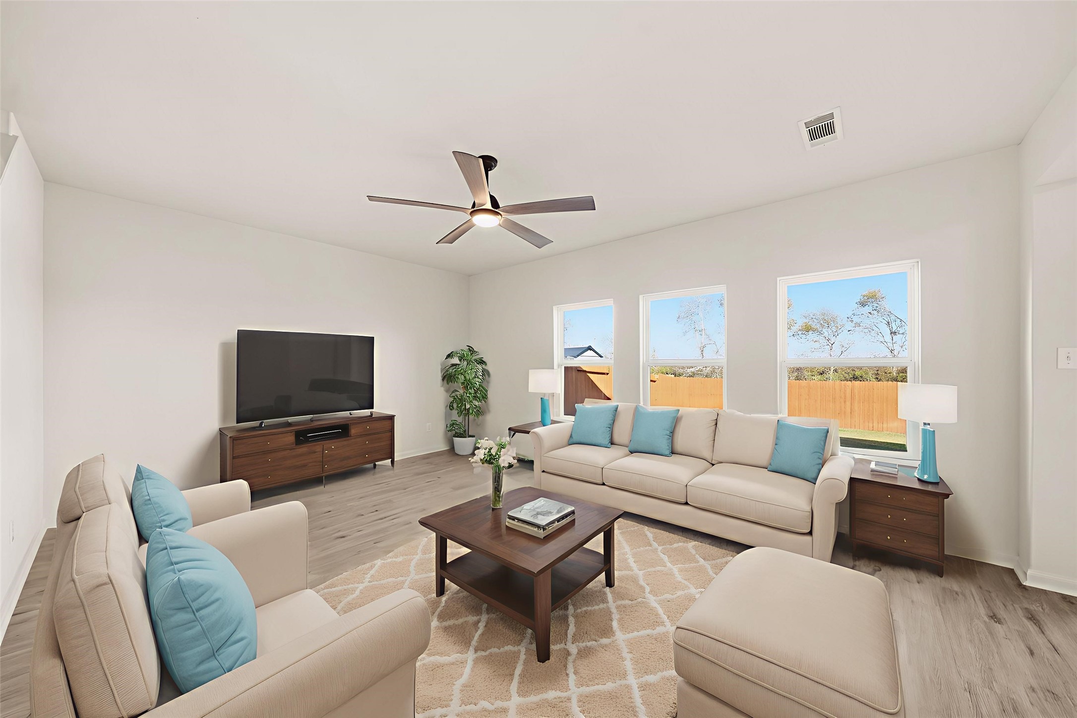 1531 Loose Stone Drive Rosharon, TX 77583 - Photo 5 of 18 Virtually Staged: This living room offers a bright, open, and comfortable space designed for both relaxing and entertaining. Large windows bring in abundant natural light and provide a pleasant view of the backyard. A ceiling fan with light fixture adds comfort and style to the room.