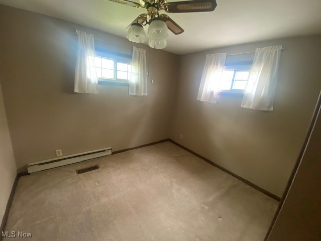 183 Trails End Road Toronto, OH 43964 - Photo 16 of 25 Spare room with a baseboard heating unit, ceiling fan, carpet flooring, baseboards, and visible vents