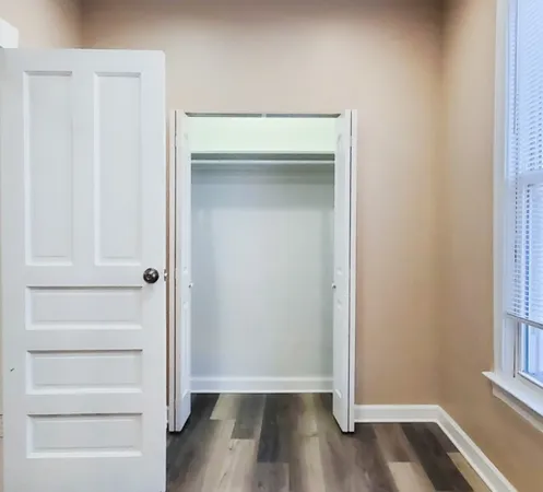 a view of walk in closet with empty racks