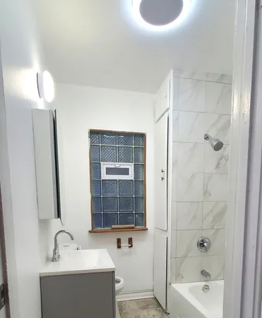 a bathroom with a bathtub a sink and a mirror