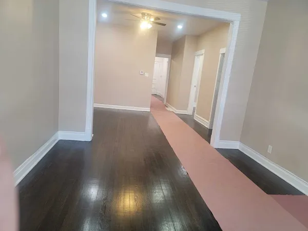 a view of a hallway with wooden floor