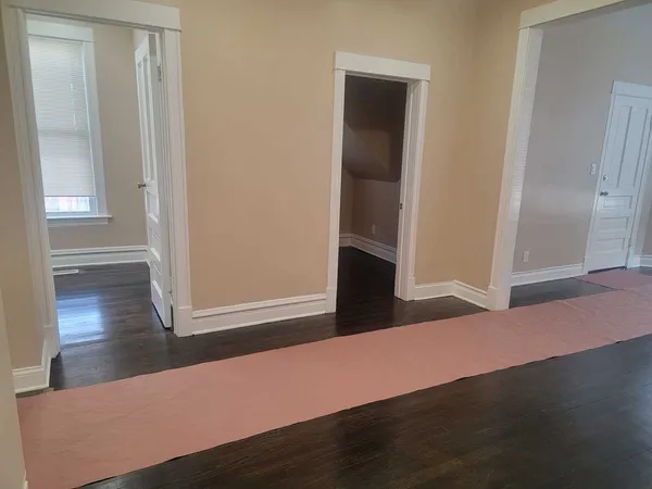 an empty room with wooden floor