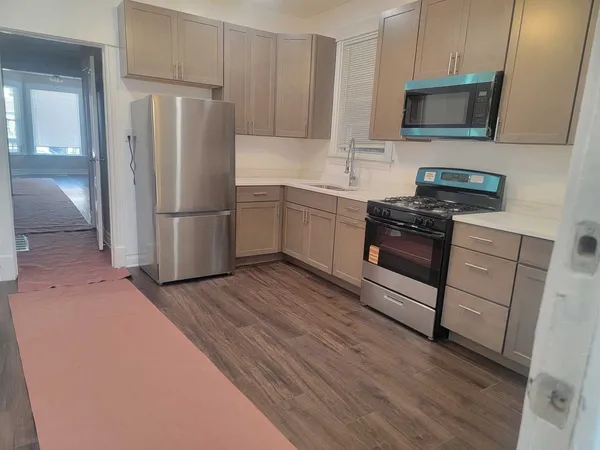 a kitchen with a refrigerator sink and microwave