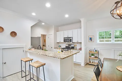 a kitchen with stainless steel appliances kitchen island granite countertop a sink and cabinets