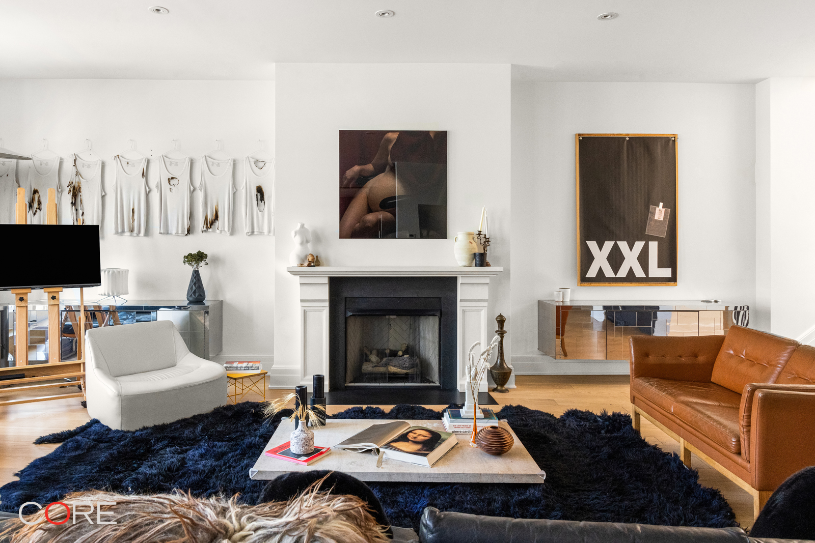 87 Leonard Street, Unit PHB Manhattan, NY 10013 - Photo 1 of 16 a living room with furniture and a fireplace