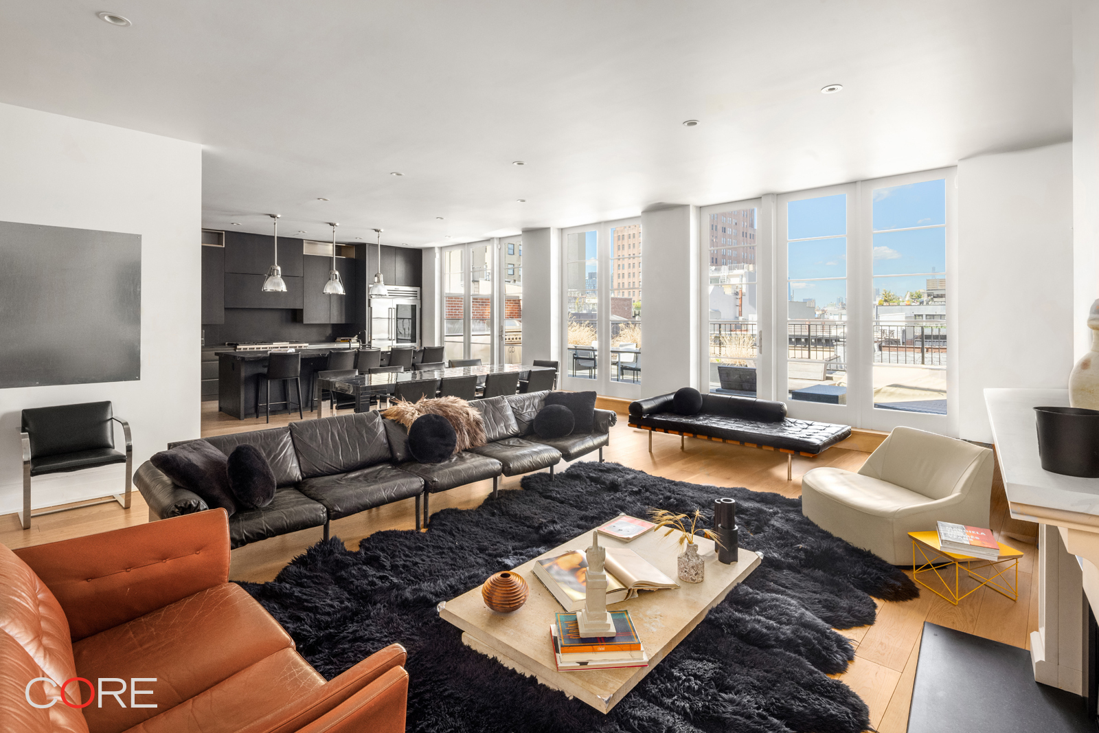 87 Leonard Street, Unit PHB Manhattan, NY 10013 - Photo 3 of 16 a living room with furniture wooden floor and a view of kitchen