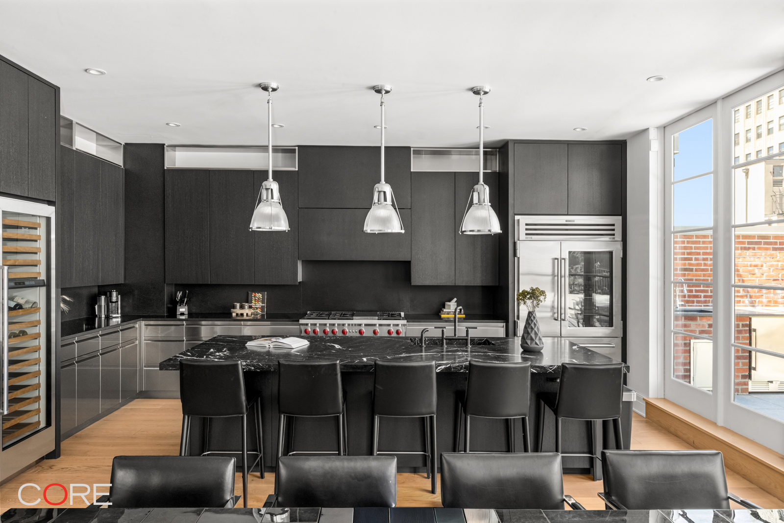 87 Leonard Street, Unit PHB Manhattan, NY 10013 - Photo 4 of 16 a kitchen with a table chairs stove and cabinets