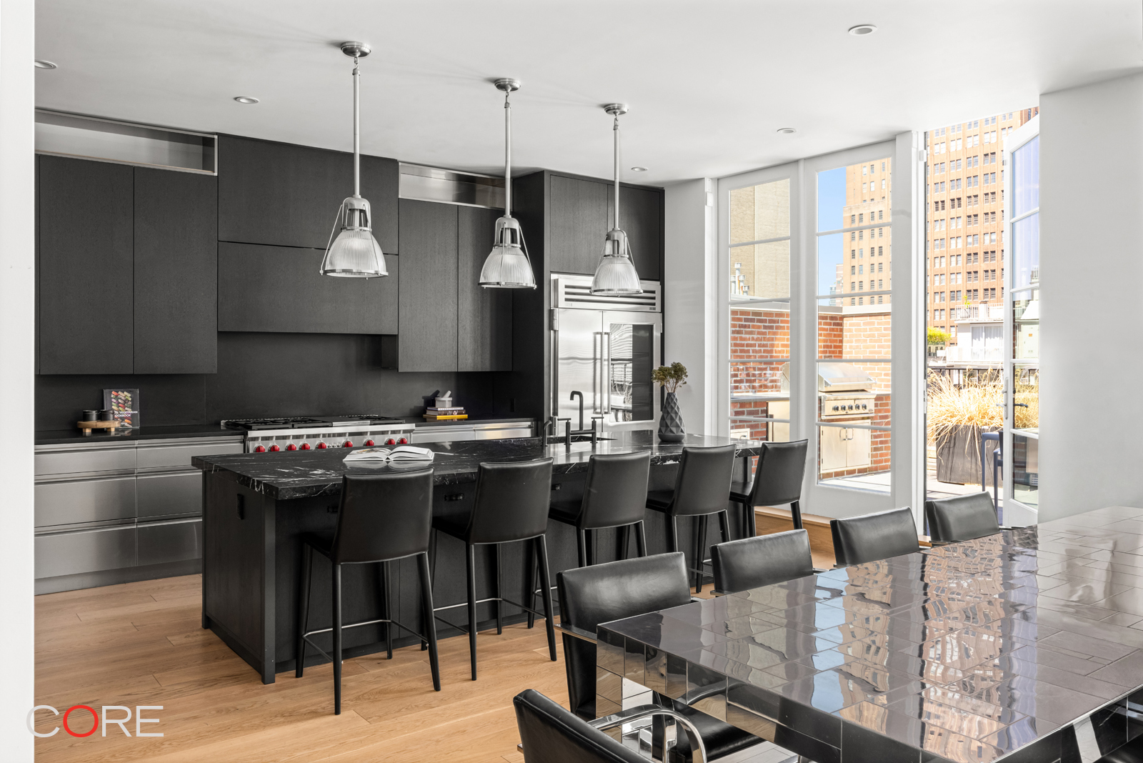 87 Leonard Street, Unit PHB Manhattan, NY 10013 - Photo 5 of 16 a kitchen with a table chairs and flat screen tv