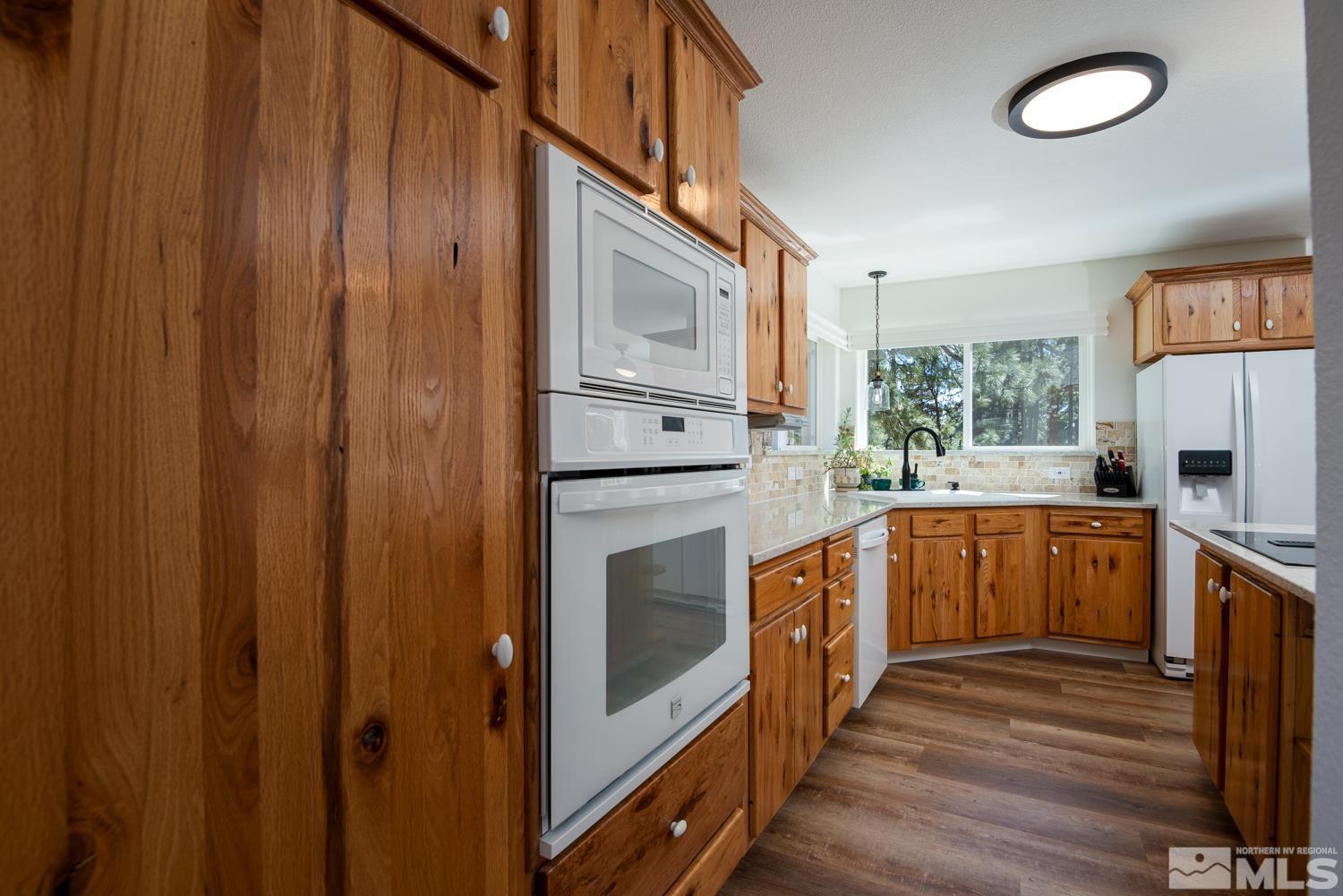 4651 Reds Grade Carson City, NV 89703 - Photo 9 of 39 a kitchen with stainless steel appliances granite countertop a refrigerator and a stove top oven