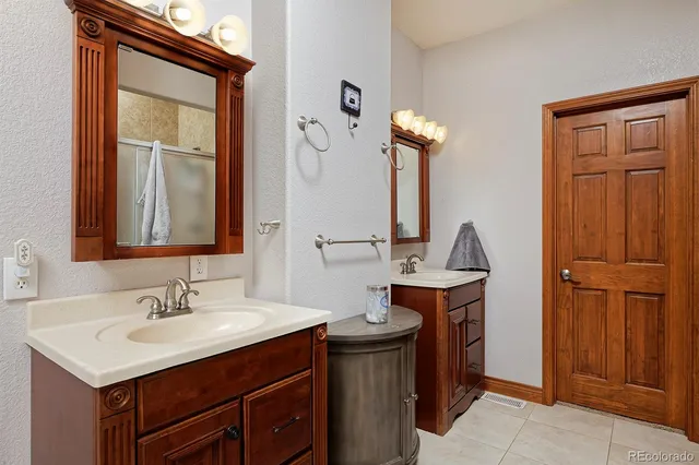 a bathroom with a sink vanity and a mirror