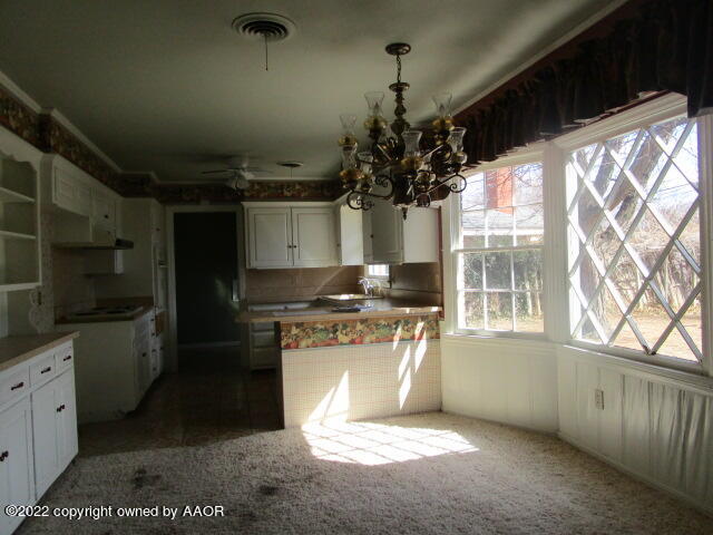 6109 Gainsborough Road Amarillo, TX 79106 - Photo 6 of 15 a kitchen with stainless steel appliances granite countertop a stove a sink and a refrigerator