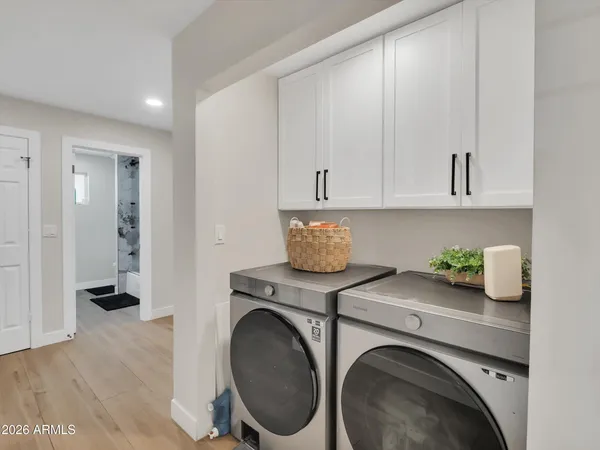a utility room with sink dryer and washer