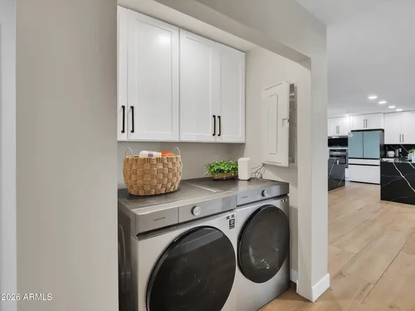 a view of a kitchen with stainless steel appliances granite countertop a refrigerator and a stove top oven