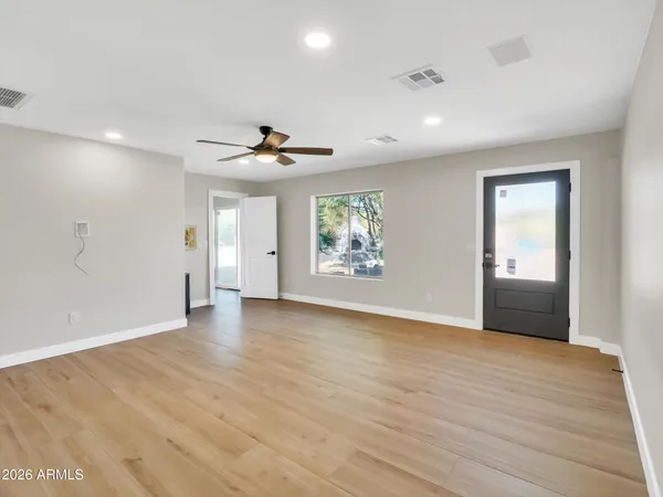 wooden floor in an empty room with a window