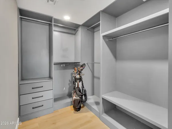 a view of walk in closet with empty racks