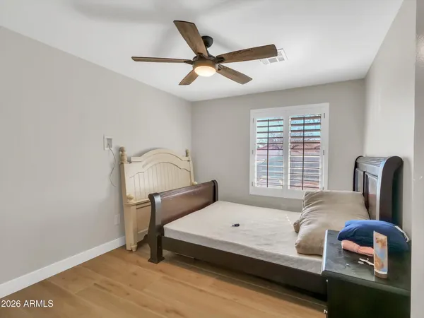 a bedroom with furniture and wooden floor