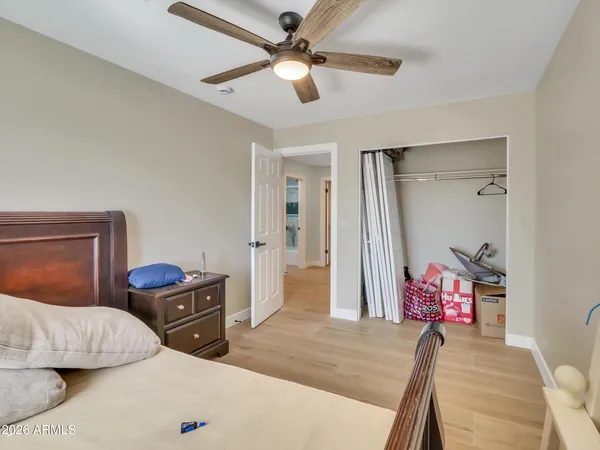 a bedroom with a bed and a chandelier
