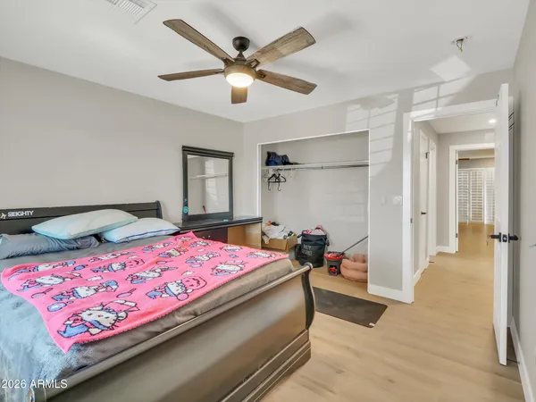 a bedroom with a bed and a chandelier