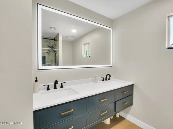 a bathroom with a double vanity sink and mirror