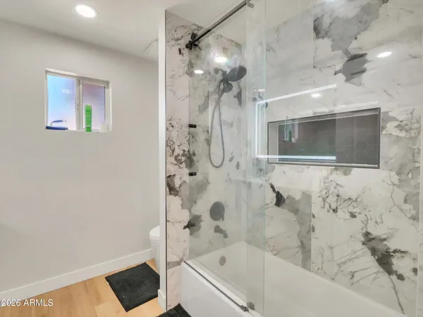 a bathroom with a bathtub and shower