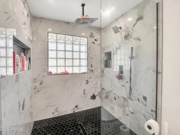 a bathroom with a bathtub and shower