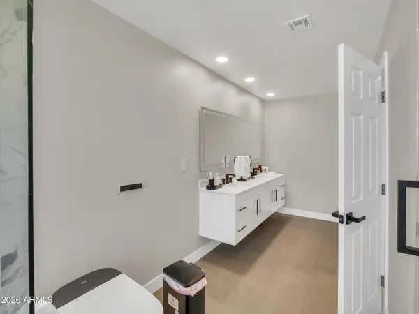 a bathroom with a bathtub sink mirror and toilet