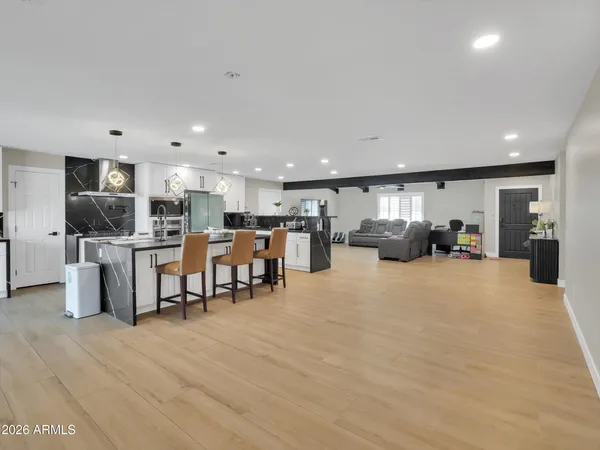 a large kitchen with a table and chairs
