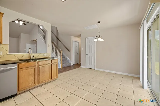 a view of entryway with kitchen island granite countertop cabinets