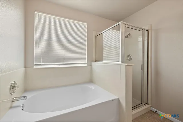 a white bath tub sitting next to a window