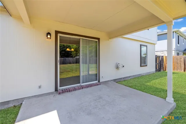 a view of a big room with sliding door and wooden floor