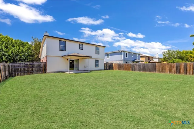 a front view of a house with a garden and yard