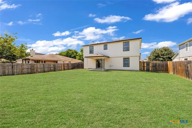 a front view of house with a garden