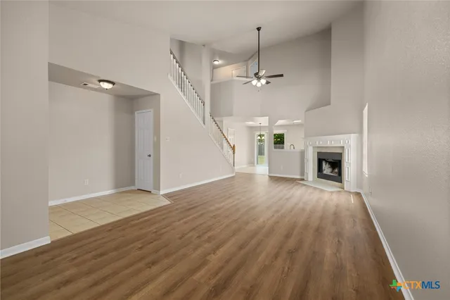 wooden floor in an empty room with a fireplace