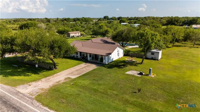 an aerial view of residential houses with outdoor space and swimming pool